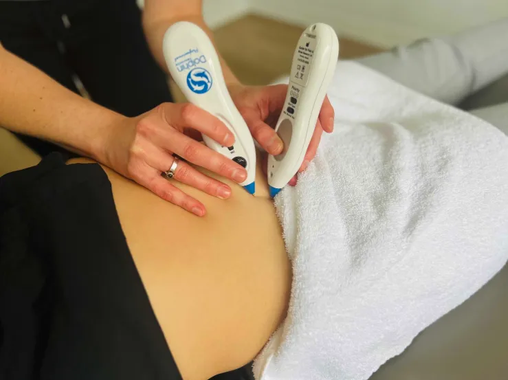 Person receiving Dolphin Neurostim therapy on their back.